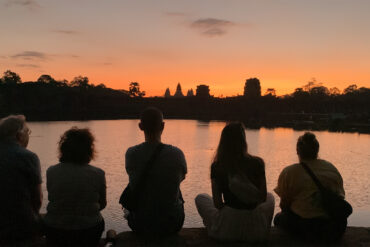 Angkor Sunrise tour sitting on the bank of outer moat of Angkor Wat