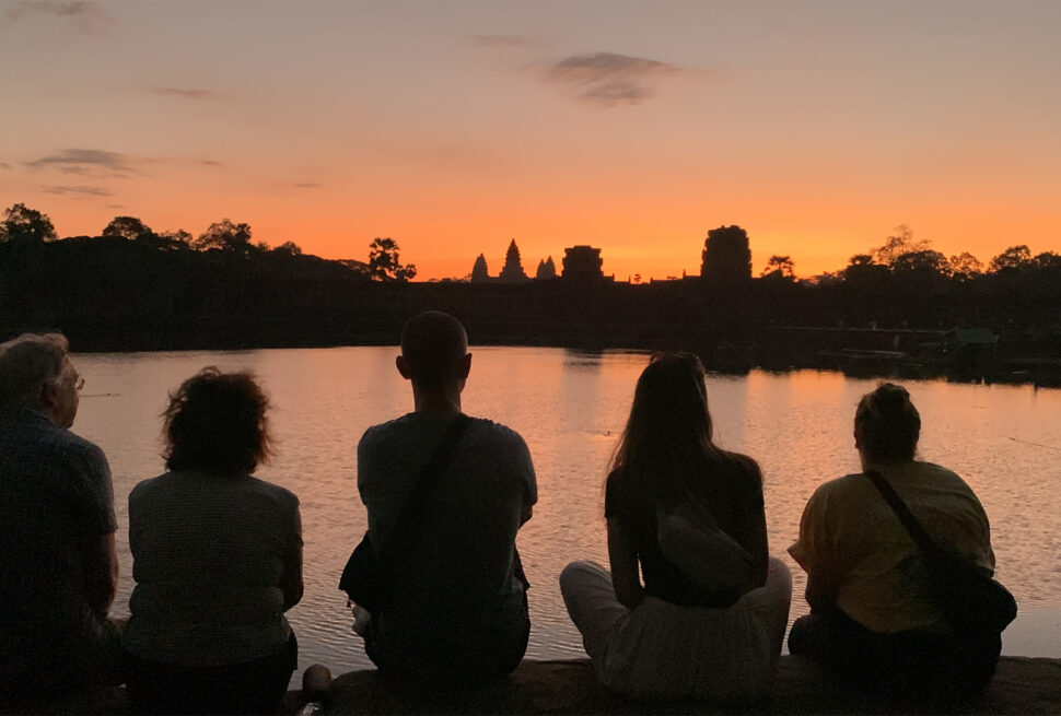 Angkor Sunrise tour sitting on the bank of outer moat of Angkor Wat