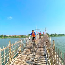 Cycling in Cambodia along the Mekong river Explore the country on two wheels, cycling on the bamboo bridge in Kampong Cham